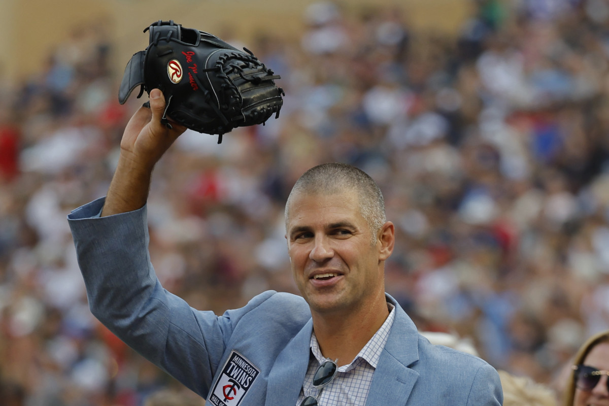 Joe Mauer waves with mitt